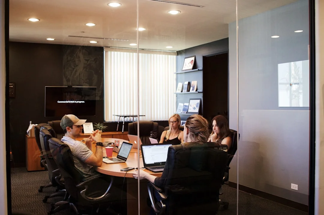 A clean and modern desk setup with a lightbox displaying #TREND and a computer monitor showing a social wall solution.